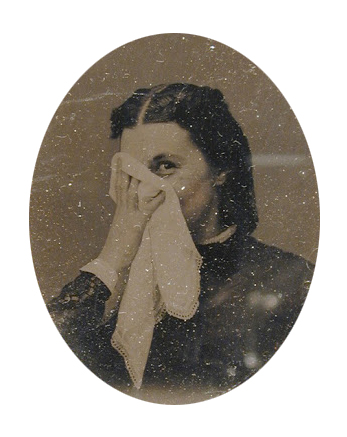 woman covering her face with a handkerchief
